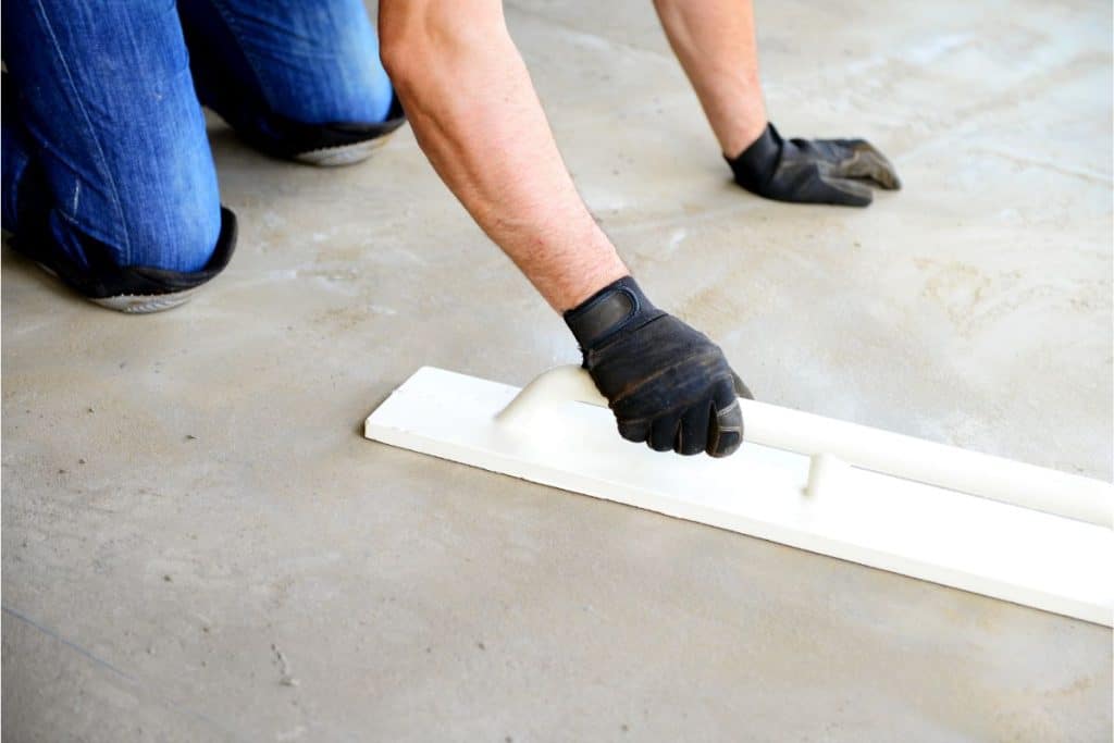 Arnold Ready Mix worker smoothing poured concrete